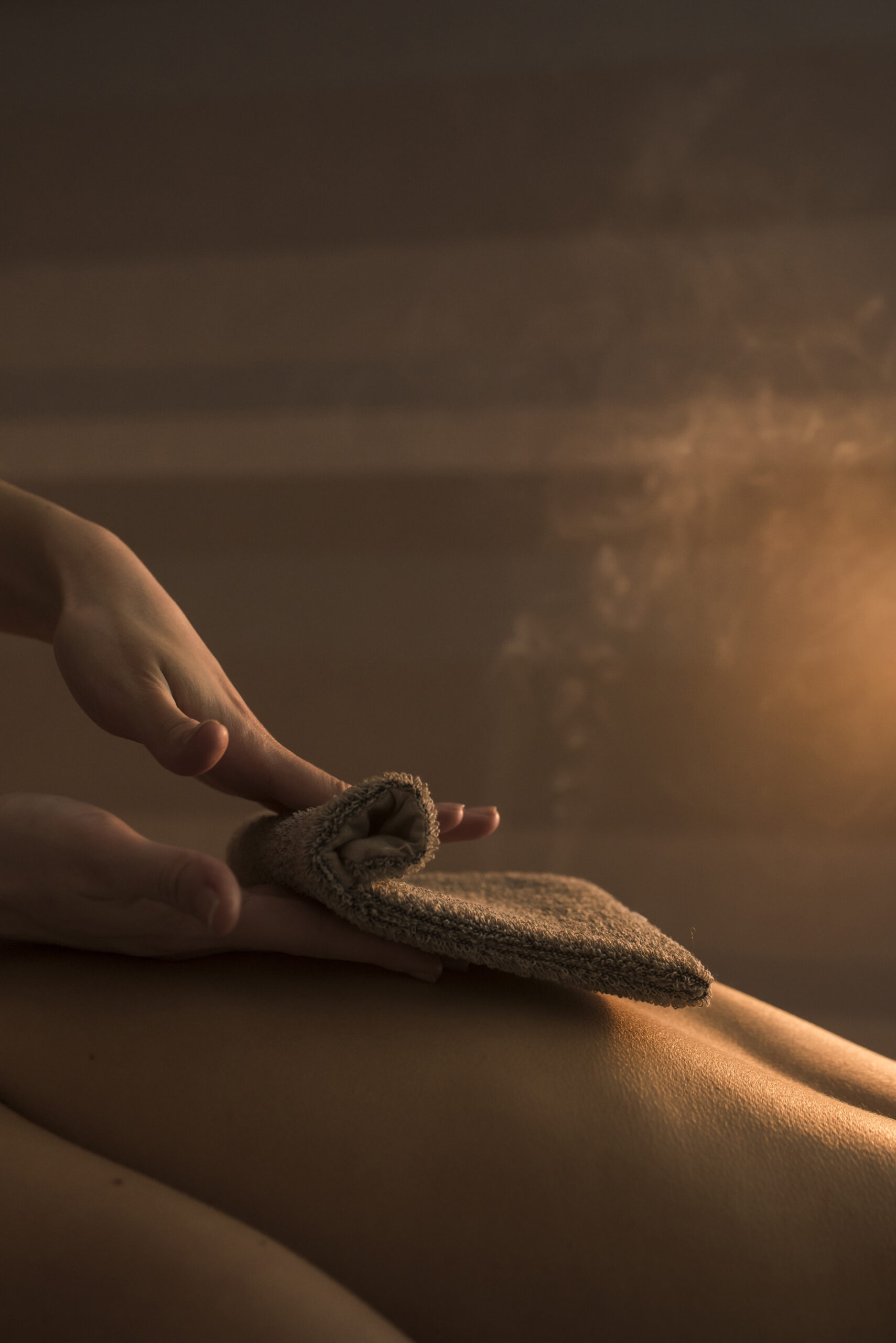 beautician hand massaging woman s back with hot towel spa beautician hand massaging woman s back with hot towel spa